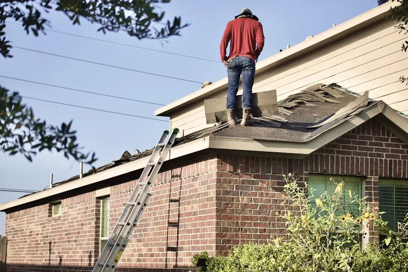Professional roofer working on a residential roof in Colony Park